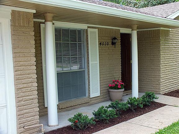 Lovely front porch and fresh landscaping.