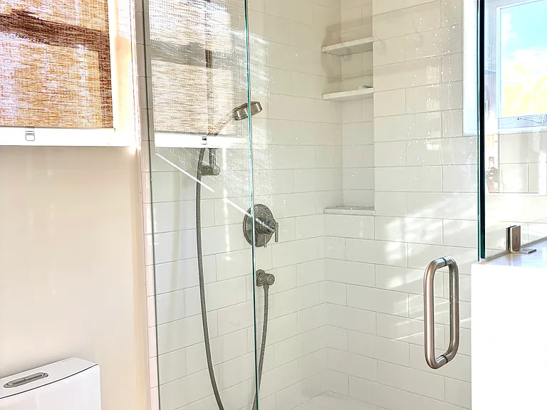 Glass shower with lots of natural light.