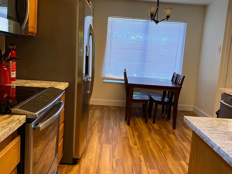 Kitchen with stainless steel appliances, breakfast table for 4