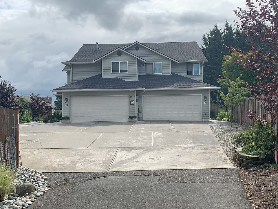 Driveway to front of home. Unit A is the left-side garage, Unit B is on the right, and Unit C stairway is furthest to the left. It is located behind and under Unit A.