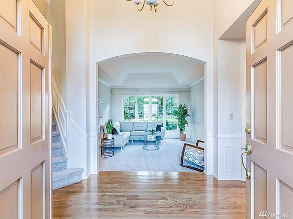 Soaring 18 foot ceilings and gleaming hardwood floors lead to the formal living room. Master Suite is to the right in it's own wing.