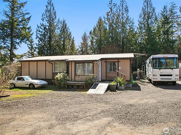 Front of home without staged bushes.>