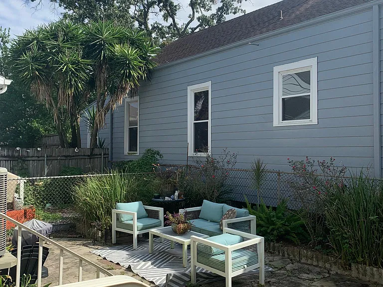 There is also a spacious backyard, accessible from both the master bedroom and a gated entrance at the front of the property