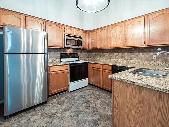 Granite countertops, ceramic tile flooring, attractive backsplash