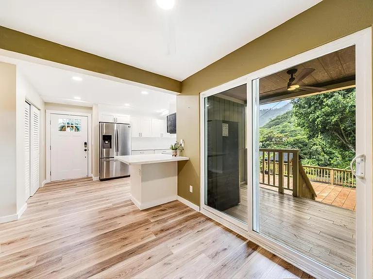 Dining area adjacent to the kitchen, with lanai and deck access