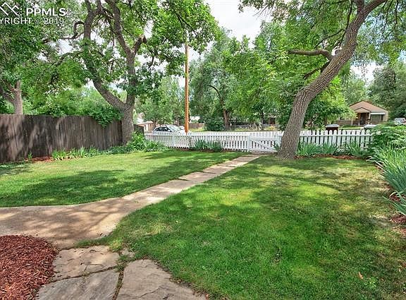 Charming front yard with stone walkways