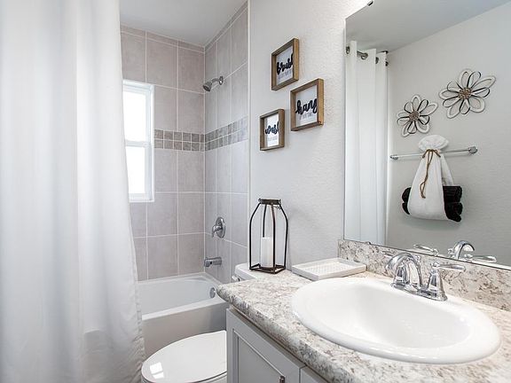 Convenient hall bath - New home for sale in Lake Wales, FL. Photo showcases a home with similar fini