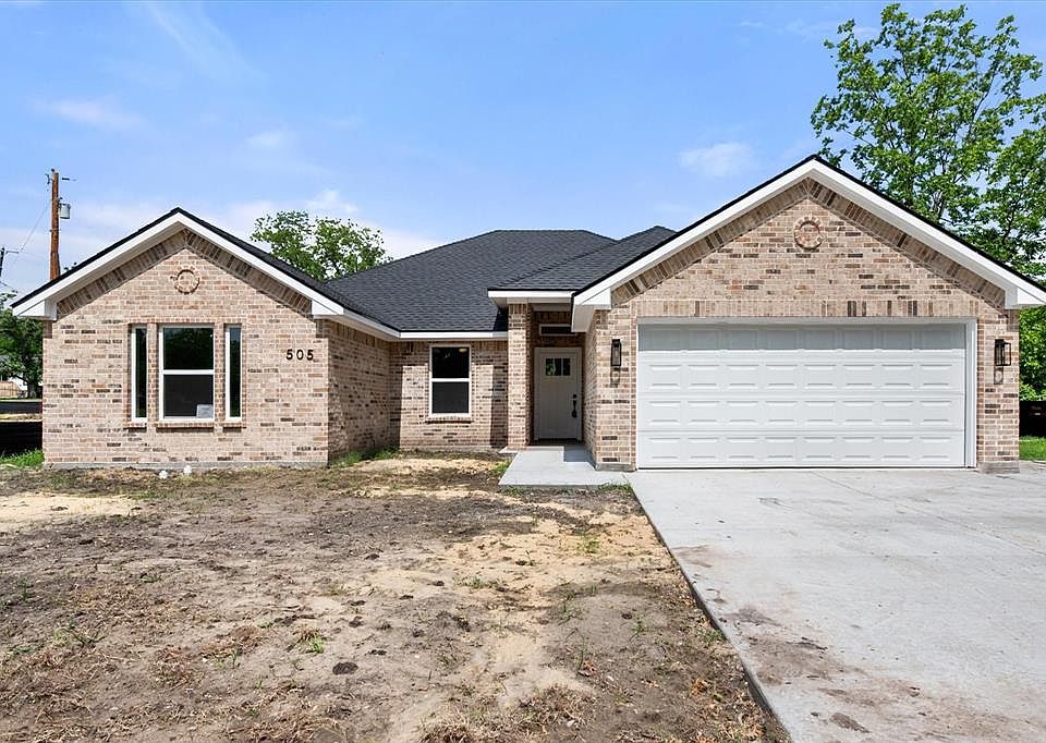 Brick exterior with a dark shingle roof and white trim