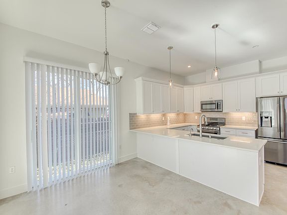 Kitchen & Dining with sliding door to side yard.