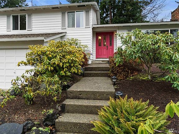 Mature, low maintenance landscaping surrounds as you approach your covered front porch and throughout the private back yard