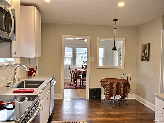 The kitchen boasts all new stainless steel appliances (including the microwave and refrigerator), new LED recessed lighting, white cabinetry & subway tile backsplash, a new faucet/sprayer, an under-counter sink plus quartz countertops!