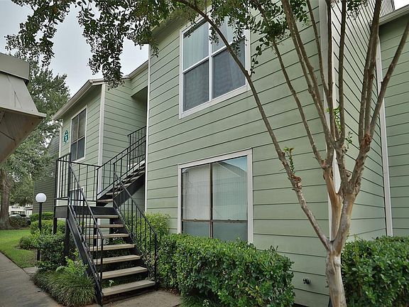 SECOND FLOOR CONDO IS PRIVATE WITH COVERED PARKING