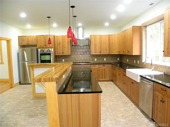Chef's dream kitchen with stainless steel appliances, double oven, granite counters and plenty of cabinets and counter space. 