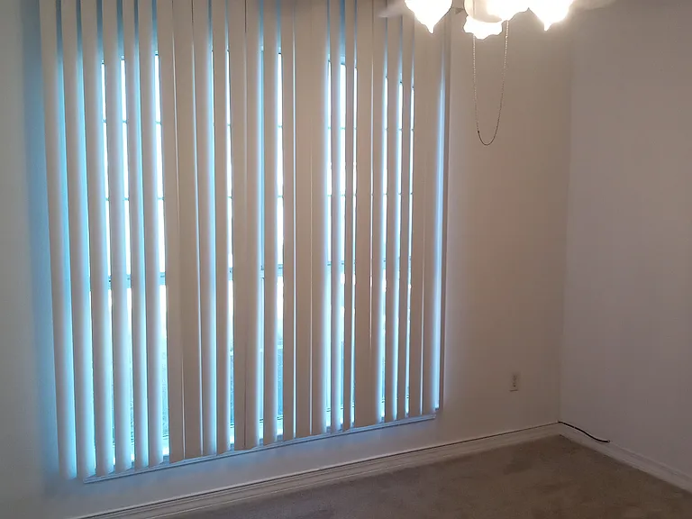 Front bedroom with vertical blinds facing Mizzen Lane.