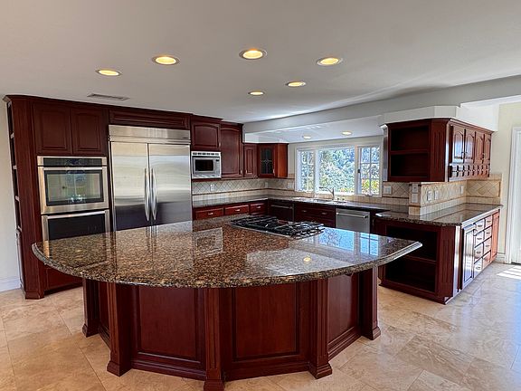 Spacious open kitchen concept with two dishwashers, wine cabinet, and generous storage.