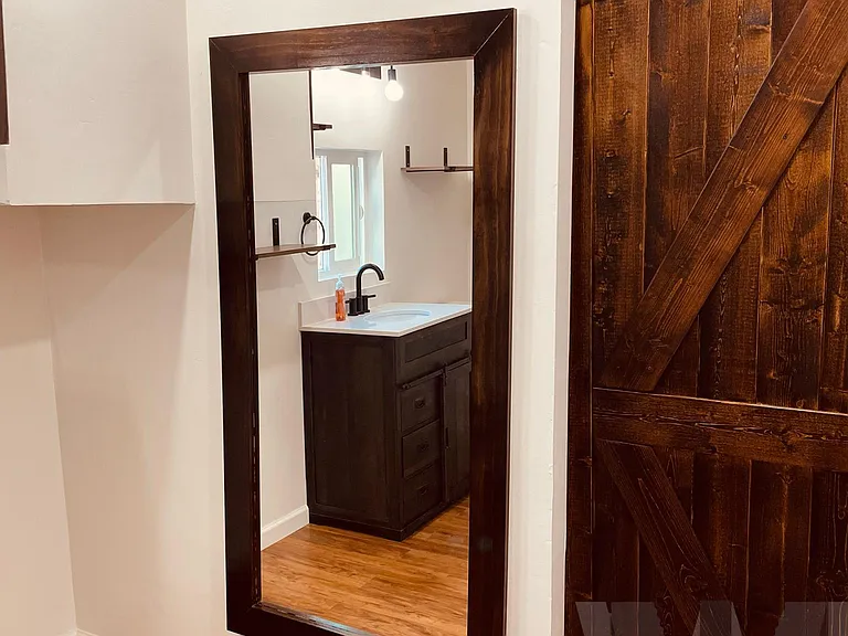Custom mirror and sliding barn door (dressers were added after this photo was taken).
