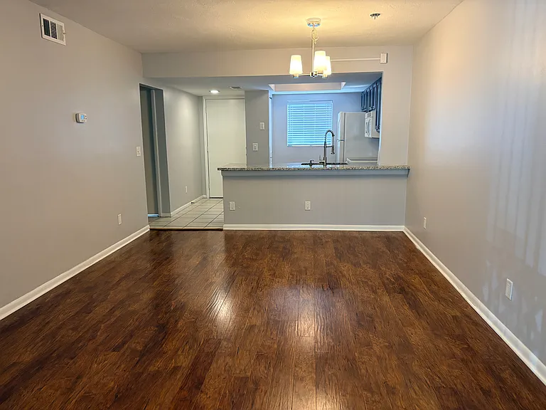 View of the dining/kitchen from den