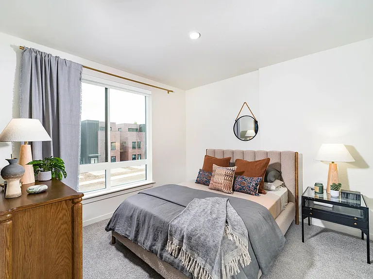 A serene bedroom retreat at Modera University Park, pairing soft finishes and natural light with a location close to University Park's dining and culture.