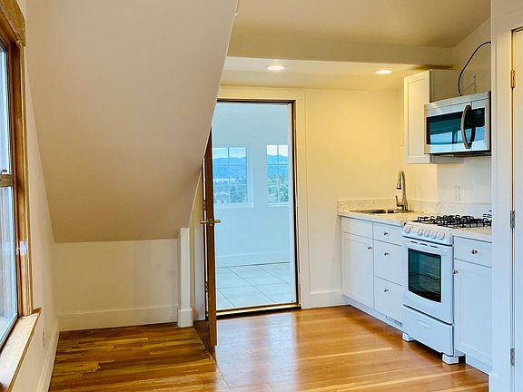 living room/ kitchen area and door to sleeping porch