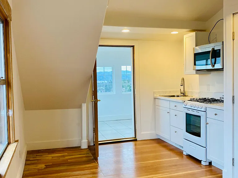 living room/ kitchen area and door to sleeping porch