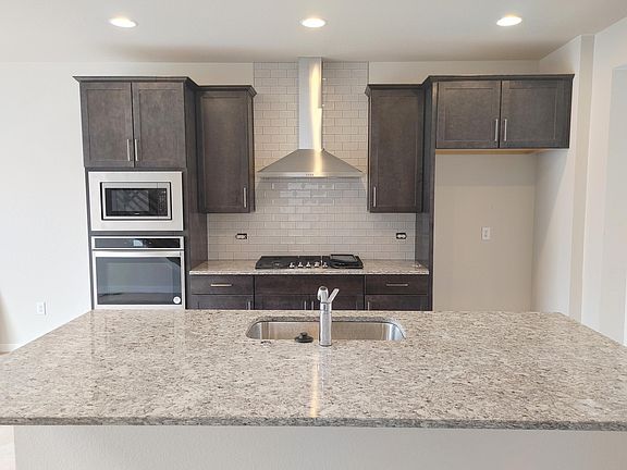 Granite Countertops complete with gourmet kitchen-stainless gas stove, mocrowave, oven, hood, dishwasher and JennAir Fridge