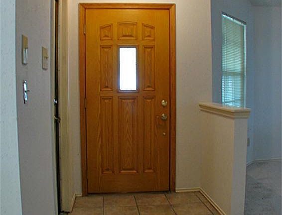 Come on  in! A tile entry leads to soft carpet in the living areas.