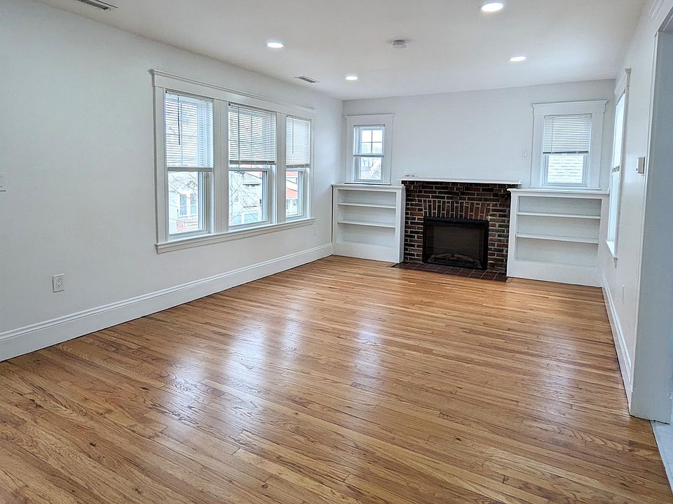 Living room with electric fireplace and built in shelves