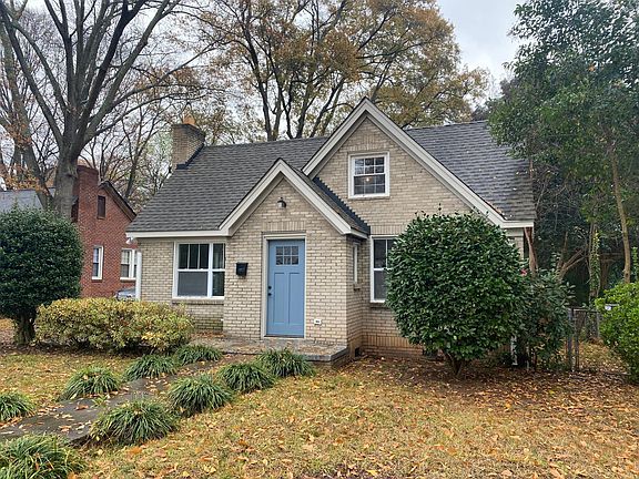 Front of brick cottage home in autumn