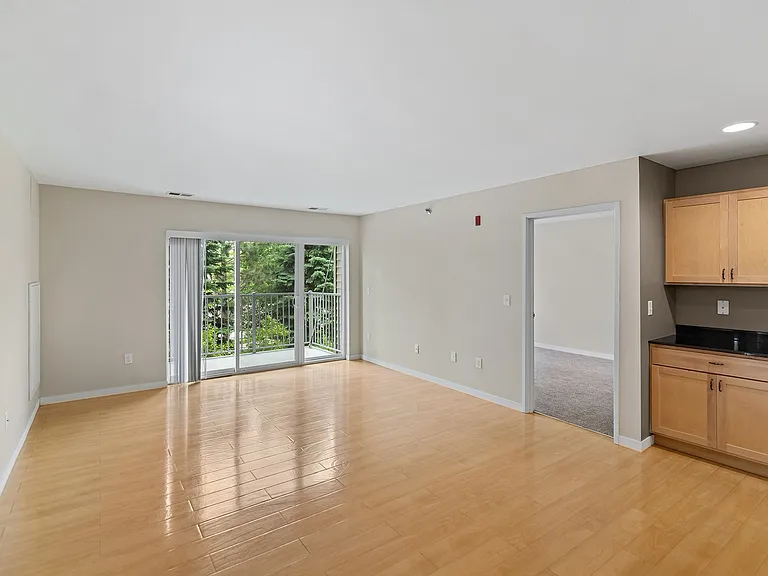 Step into the bright and airy living space of Overlook Ridge. This stunning apartment features ample natural light, sleek hardwood floors, and serene views from the sliding glass doors. Schedule your tour today to see it for yourself!
