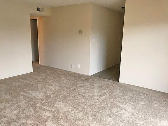 Living room with entry area and hall to bedrooms and storage