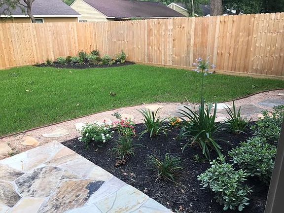 Beautiful landscaping with privacy fence.