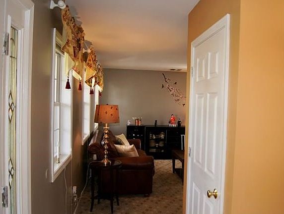 View of living room from foyer.  Coat closet on right.