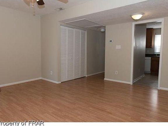 The hidden washer and dryer hookup is behind the bi-fold doors next to the water heater. The area accommodates a full-size set.