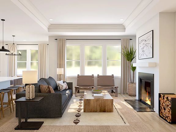Great room with tray ceiling featuring crown moulding