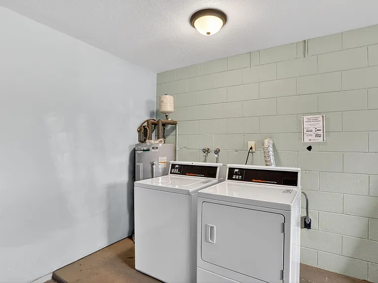 On-site laundry area with a full-size washer and dryer setup and utility connections for everyday convenience.