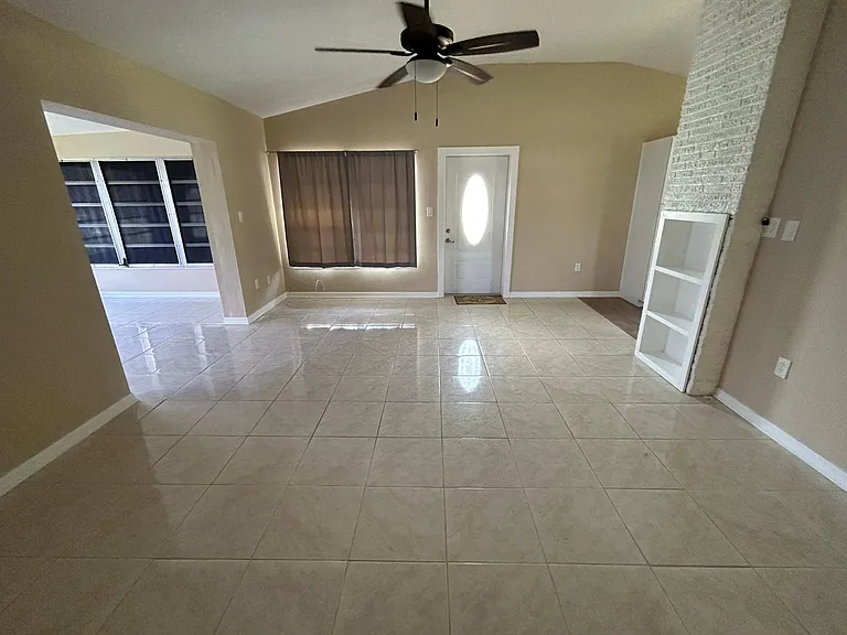Living Room / Front Door. New Ceiling Fan. Room measures 14' wide x 18' deep.