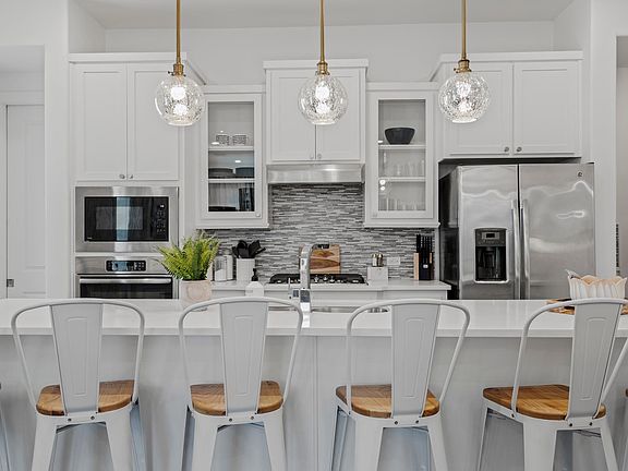 Large kitchen island and high end appliances with gas stove and XL pantry.
