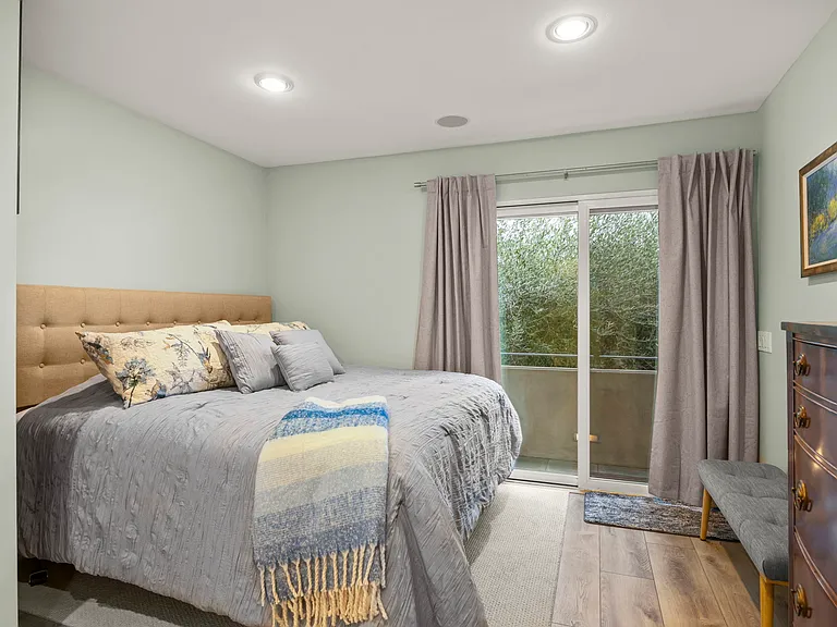 Primary bedroom with king sized bed. Access to deck and lower patio.