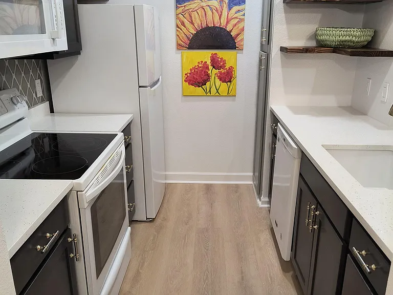 Kitchen with electric range, microwave, dishwasher, refrigerator with icemaker, pantry, and all new cabinets.