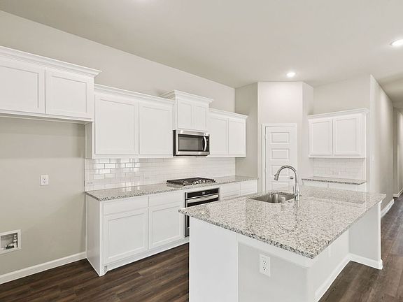 Kitchen in the Quartz home plan by Trophy Signature Homes - REPRESENTATIVE PHOTO