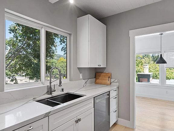Brand new quartz countertops, tasteful fixtures and big window with leafy view.