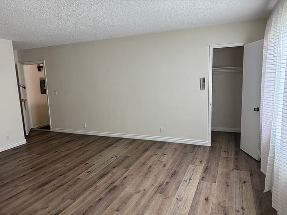 View of living room from the dining room area. Shows the entrance and livingroom closet