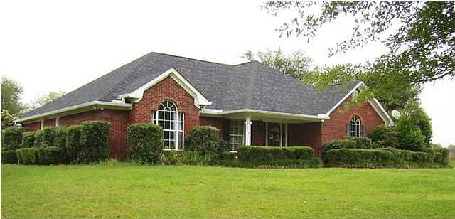 Lovely brick home is in a quiet country setting.