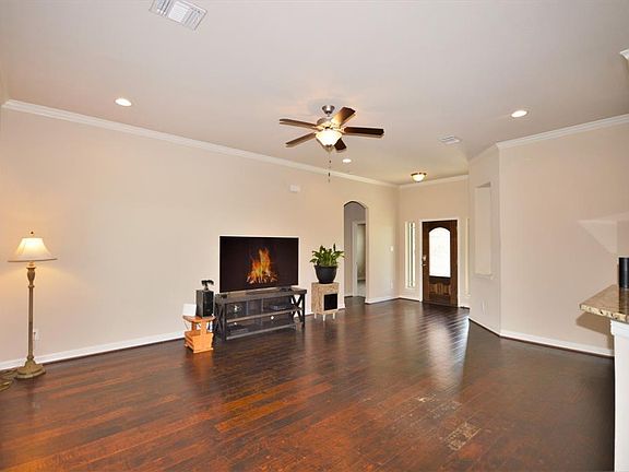 Large living area with engineered wood flooring and an abundance of natural lighting for entertaining.