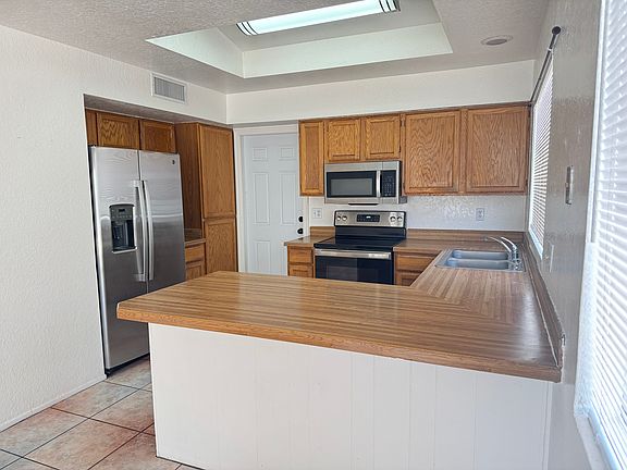 Kitchen has newer stainless steel refrigerator, range and microwave