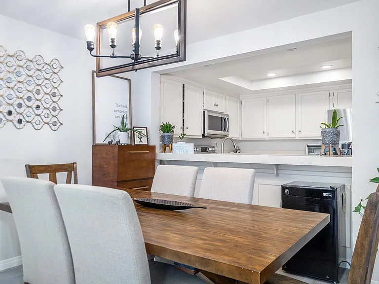 Spacious dining room to comfortably seat family and friends with farmhouse style chandelier