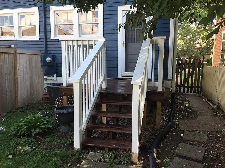 Back porch leading to fenced backyard.