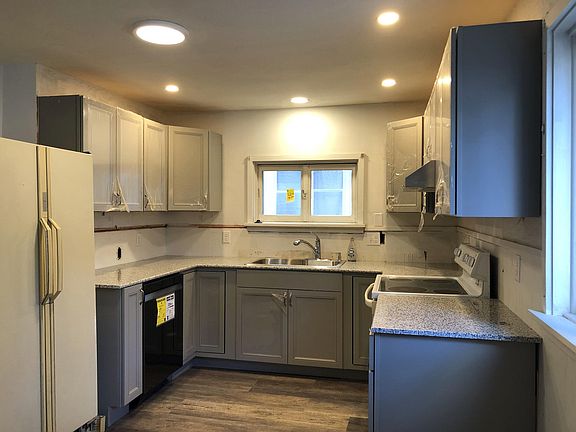 Kitchen with new cabinets, dishwasher, disposal and granite countertop