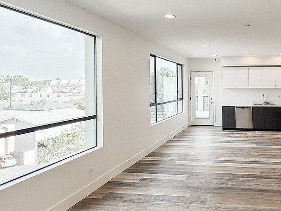 Huge open loft style living/dining/kitchen with doorway to generous balcony