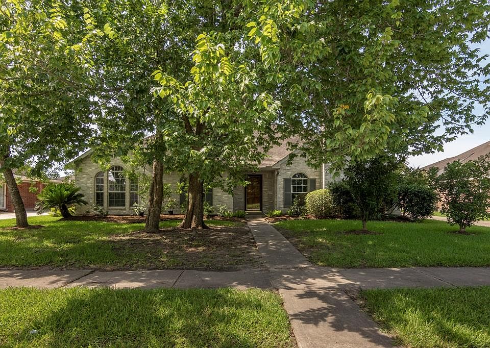 Great home in The Meadows offers tranquil setting, mature landscaping, all brick exterior and a detached garage.